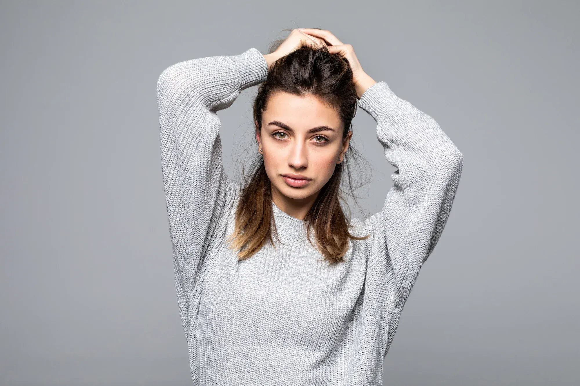Patient examining widening hair part in soft natural light